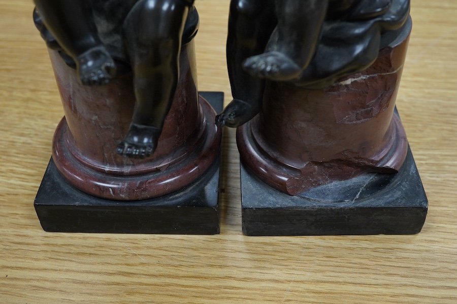 A pair of 19th century French bronze figures of children playing instruments, raised on rouge marble columns, 23cm high. Condition - poor